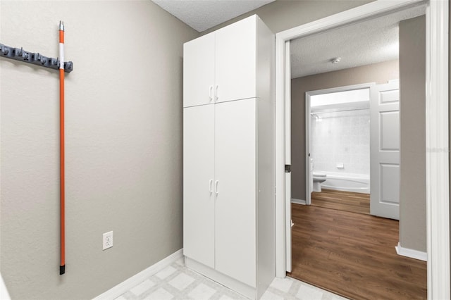 8175 Sturbridge Unit 8175, Weeki Wachee, FL 34613 - unfurnished bedroom with a textured ceiling and light wood finished floors