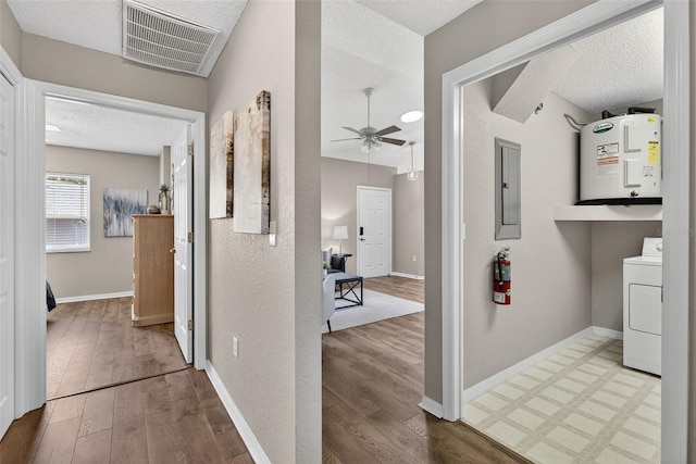 8175 Sturbridge Unit 8175, Weeki Wachee, FL 34613 - corridor with washer / clothes dryer, electric panel, wood finished floors, and a textured ceiling