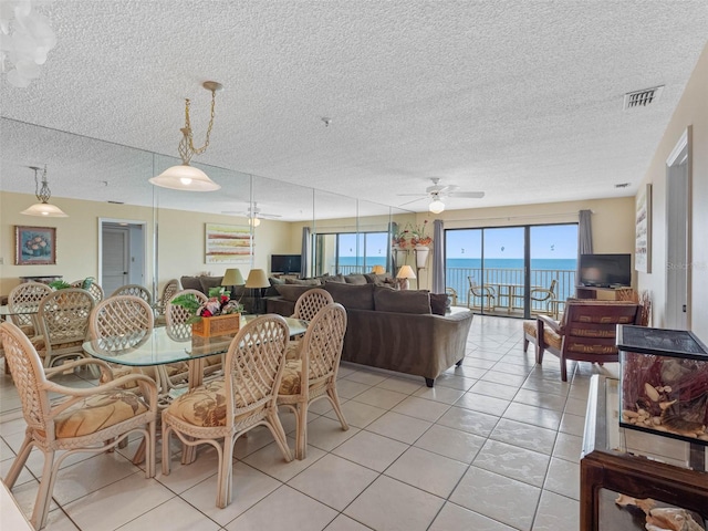 13500 Gulf Blvd Unit 706, Madeira Beach, FL 33708 - dining area featuring a ceiling fan, light tile patterned floors, and a textured ceiling