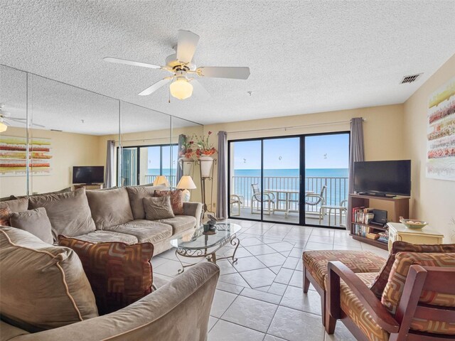 13500 Gulf Blvd Unit 706, Madeira Beach, FL 33708 - living room with a ceiling fan, a textured ceiling, and light tile patterned floors