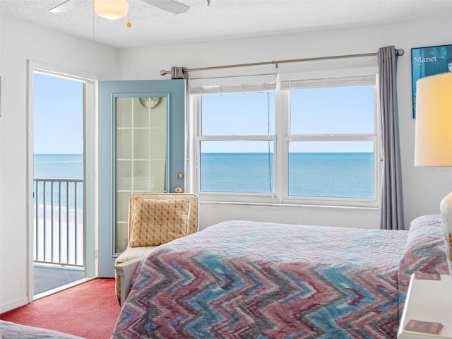 13500 Gulf Blvd Unit 706, Madeira Beach, FL 33708 - bedroom with a water view, carpet, a textured ceiling, and a ceiling fan