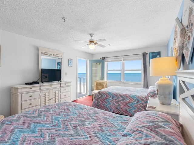 13500 Gulf Blvd Unit 706, Madeira Beach, FL 33708 - bedroom featuring a textured ceiling, access to outside, and a ceiling fan