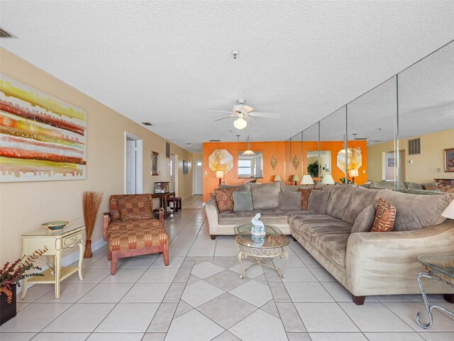13500 Gulf Blvd Unit 706, Madeira Beach, FL 33708 - living room featuring ceiling fan, light tile patterned flooring, and a textured ceiling