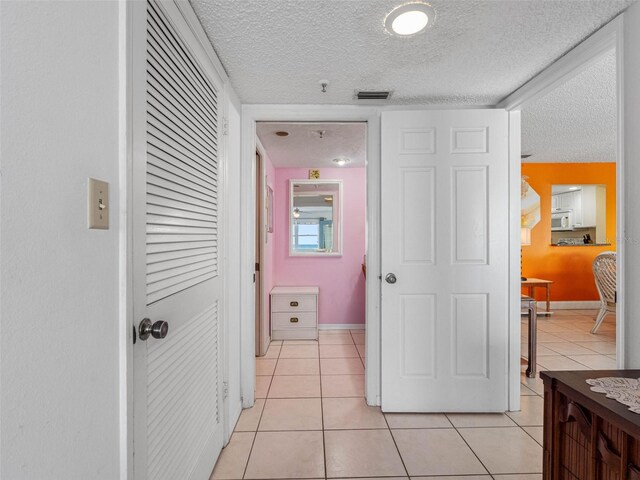 13500 Gulf Blvd Unit 706, Madeira Beach, FL 33708 - corridor with a textured ceiling, light tile patterned floors, and baseboards