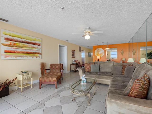 13500 Gulf Blvd Unit 706, Madeira Beach, FL 33708 - living area with a ceiling fan, a textured ceiling, light tile patterned floors, and baseboards