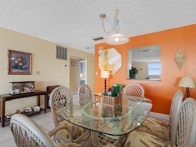 13500 Gulf Blvd Unit 706, Madeira Beach, FL 33708 - tiled dining space featuring a textured ceiling and baseboards