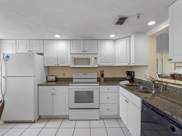 13500 Gulf Blvd Unit 706, Madeira Beach, FL 33708 - kitchen featuring white appliances, a sink, white cabinetry, recessed lighting, and dark stone countertops