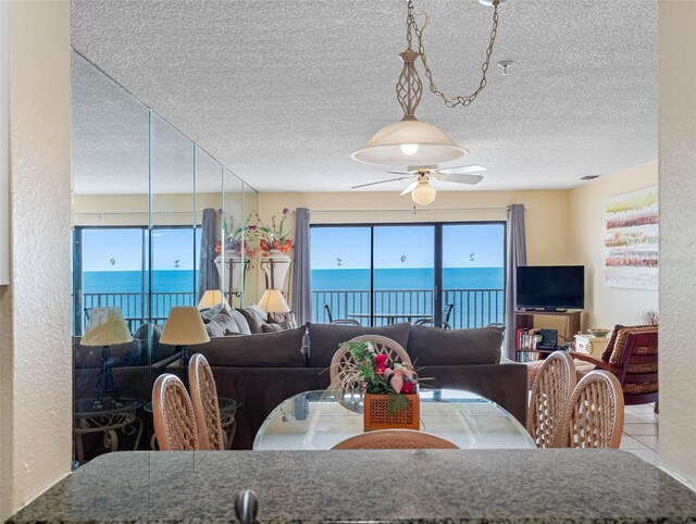 13500 Gulf Blvd Unit 706, Madeira Beach, FL 33708 - dining room with ceiling fan, a textured ceiling, and tile patterned floors