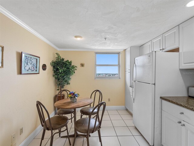 13500 Gulf Blvd Unit 706, Madeira Beach, FL 33708 - dining area with baseboards, crown molding, and light tile patterned floors