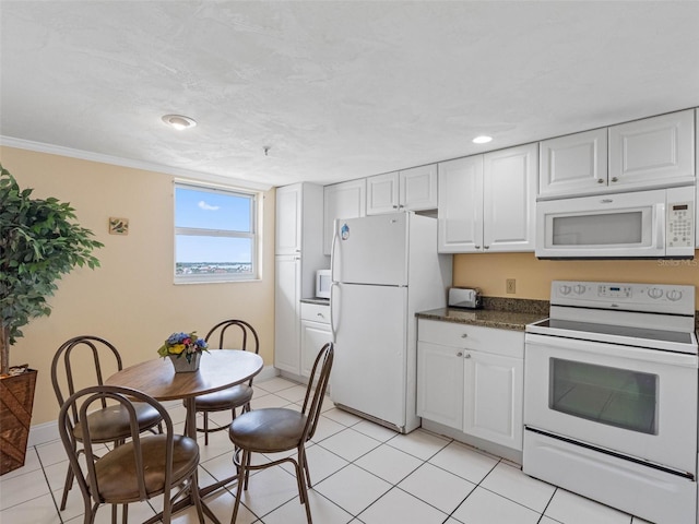 13500 Gulf Blvd Unit 706, Madeira Beach, FL 33708 - kitchen with white appliances, dark countertops, white cabinets, recessed lighting, and light tile patterned floors