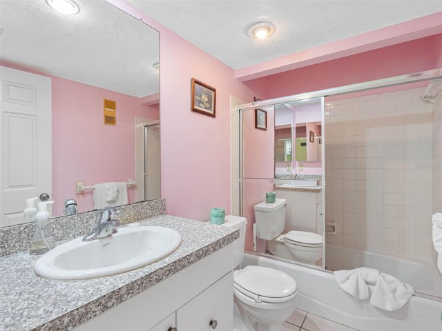 13500 Gulf Blvd Unit 706, Madeira Beach, FL 33708 - bathroom with vanity, toilet, enclosed tub / shower combo, and tile patterned flooring