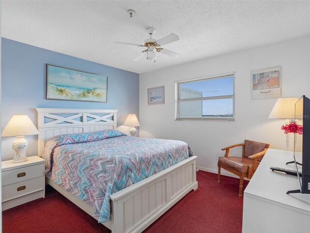 13500 Gulf Blvd Unit 706, Madeira Beach, FL 33708 - bedroom featuring dark carpet, a textured ceiling, and a ceiling fan
