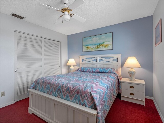 13500 Gulf Blvd Unit 706, Madeira Beach, FL 33708 - carpeted bedroom featuring baseboards, a closet, a textured ceiling, and a ceiling fan