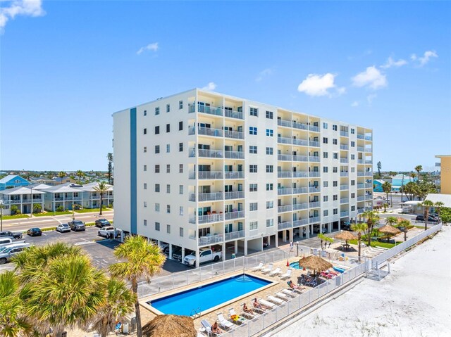 13500 Gulf Blvd Unit 706, Madeira Beach, FL 33708 - view of apartment building / complex featuring uncovered parking and a community pool