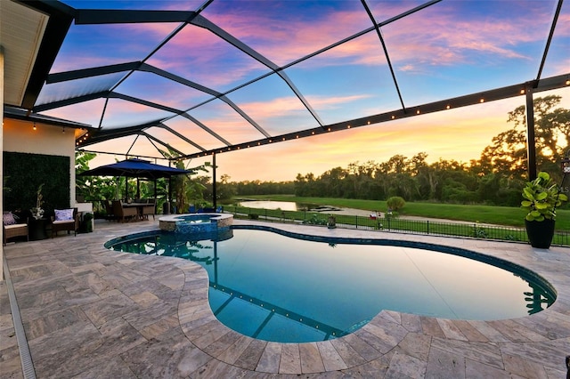 15936 Ternglade Dr, Lithia, FL 33547 - pool at dusk featuring a patio, a pool with connected hot tub, a lanai, and a gazebo