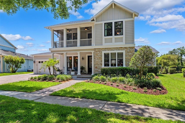 15936 Ternglade Dr, Lithia, FL 33547 - view of front facade with a balcony, covered porch, board and batten siding, stone siding, and a front yard