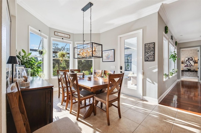 15936 Ternglade Dr, Lithia, FL 33547 - dining space with ornamental molding, light tile patterned floors, baseboards, and a chandelier