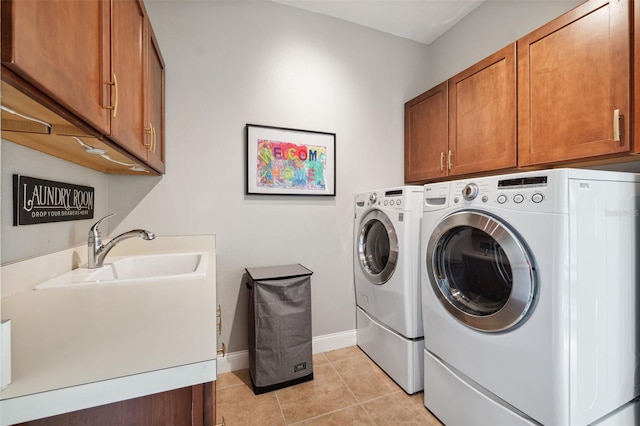 15936 Ternglade Dr, Lithia, FL 33547 - laundry room featuring cabinet space, washing machine and clothes dryer, baseboards, and light tile patterned floors