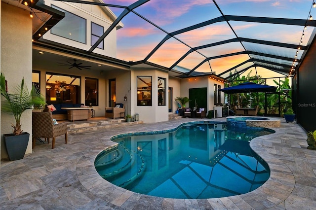 15936 Ternglade Dr, Lithia, FL 33547 - pool at dusk featuring outdoor lounge area, a patio area, ceiling fan, and a pool with connected hot tub