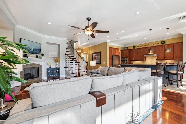 15936 Ternglade Dr, Lithia, FL 33547 - living area featuring recessed lighting, stairs, dark wood-style floors, a glass covered fireplace, and ceiling fan