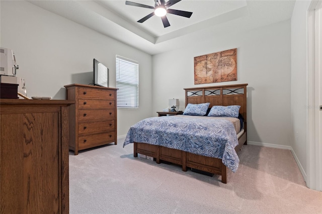 12401 Shining Willow St, Riverview, FL 33579 - bedroom featuring light carpet, baseboards, ceiling fan, and a tray ceiling