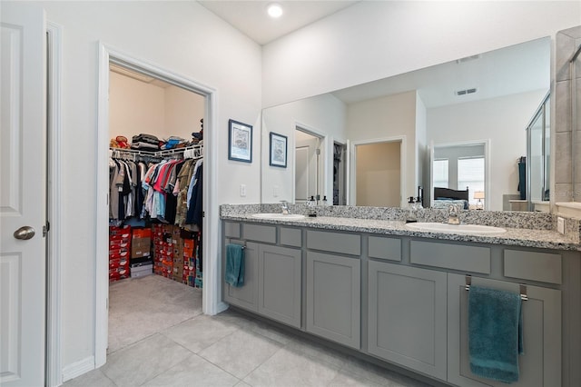 12401 Shining Willow St, Riverview, FL 33579 - full bath with double vanity, a walk in closet, and tile patterned floors