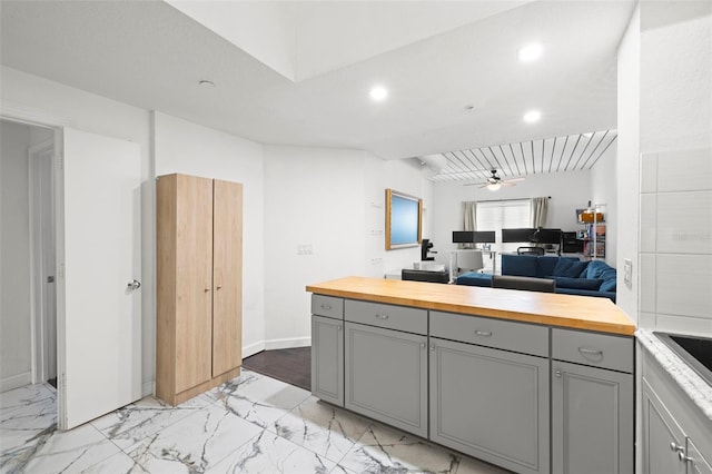 2410 W Azeele St Unit 214, Tampa, FL 33609 - kitchen with gray cabinetry, butcher block countertops, ceiling fan, light marble finish flooring, and open floor plan
