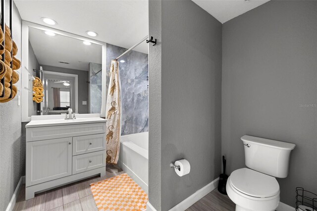 2410 W Azeele St Unit 214, Tampa, FL 33609 - full bathroom featuring vanity, shower / bath combo with shower curtain, and wood finished floors