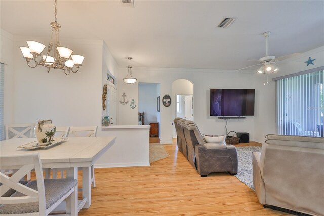 2316 Lyndhurst Dr, Sun City Center, FL 33573 - living room with light wood-type flooring, arched walkways, a chandelier, crown molding, and ceiling fan