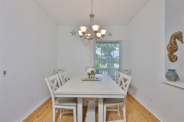 2316 Lyndhurst Dr, Sun City Center, FL 33573 - dining room with a chandelier, light wood-style flooring, ornamental molding, and baseboards