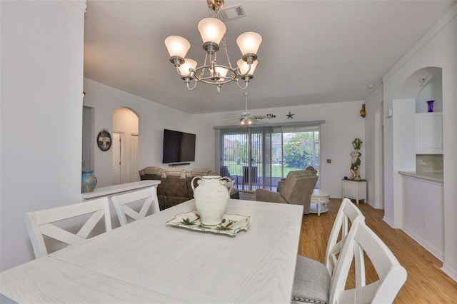 2316 Lyndhurst Dr, Sun City Center, FL 33573 - dining room featuring arched walkways, light wood-type flooring, a chandelier, and crown molding