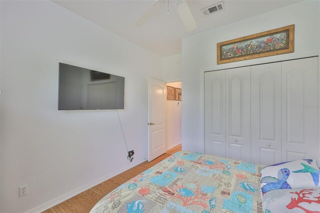 2316 Lyndhurst Dr, Sun City Center, FL 33573 - bedroom featuring wood finished floors, a closet, baseboards, and ceiling fan
