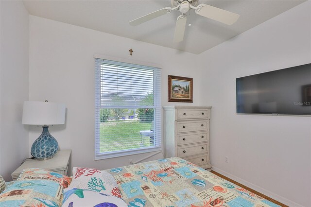 2316 Lyndhurst Dr, Sun City Center, FL 33573 - bedroom with multiple windows, baseboards, ceiling fan, and wood finished floors