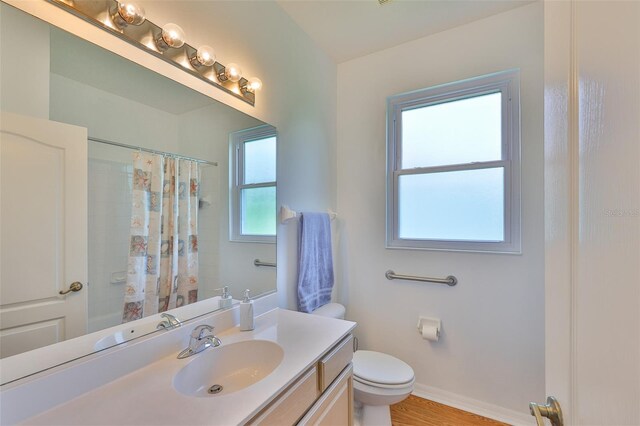 2316 Lyndhurst Dr, Sun City Center, FL 33573 - full bath featuring toilet, vanity, curtained shower, and baseboards