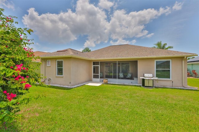 2316 Lyndhurst Dr, Sun City Center, FL 33573 - back of house featuring stucco siding, a yard, and a sunroom