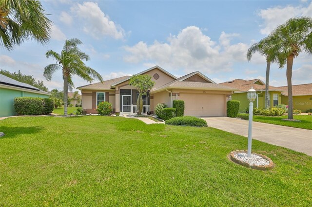 2316 Lyndhurst Dr, Sun City Center, FL 33573 - ranch-style house featuring stucco siding, driveway, a garage, and a front lawn
