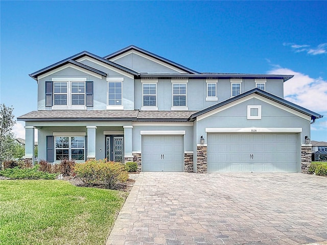 7628 Surf Reed Way, Wesley Chapel, FL 33545 - view of front of property with stone siding, stucco siding, decorative driveway, and a front lawn