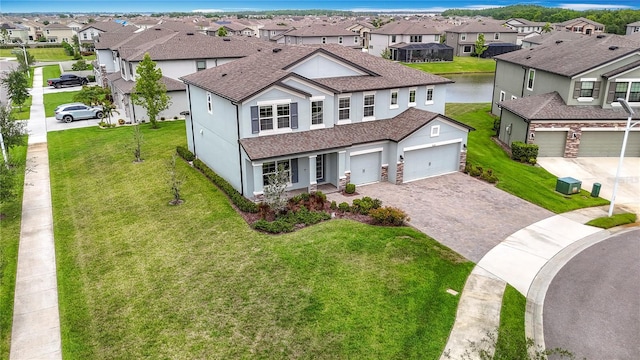 7628 Surf Reed Way, Wesley Chapel, FL 33545 - traditional-style home with a residential view, decorative driveway, a shingled roof, and stucco siding