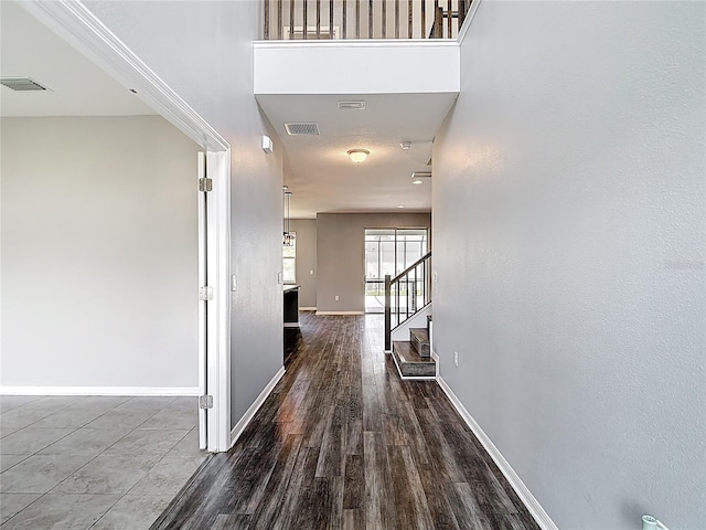 7628 Surf Reed Way, Wesley Chapel, FL 33545 - corridor featuring baseboards, stairs, and dark wood-type flooring