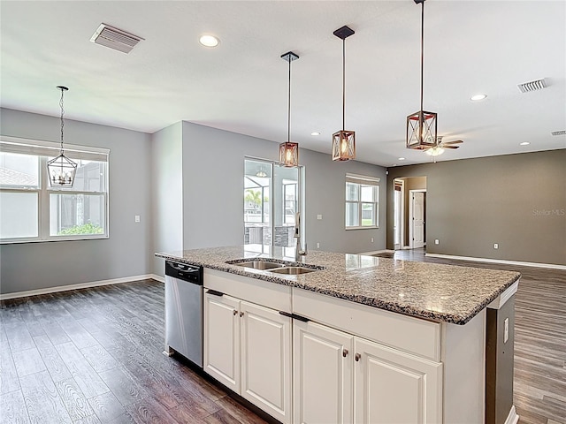 7628 Surf Reed Way, Wesley Chapel, FL 33545 - kitchen with dishwasher, a sink, dark wood-style flooring, an island with sink, and baseboards