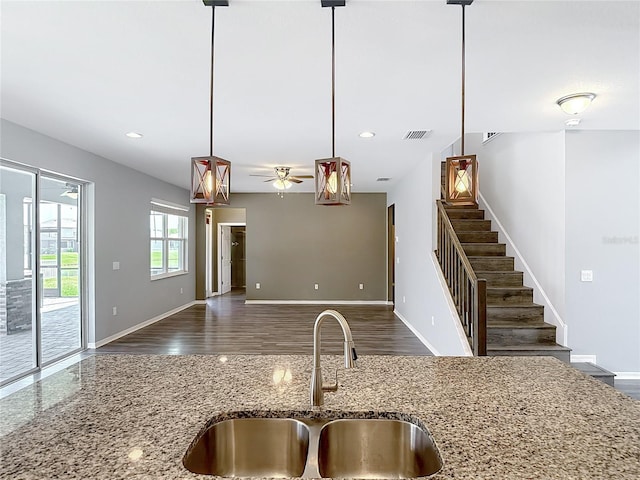 7628 Surf Reed Way, Wesley Chapel, FL 33545 - kitchen with a sink, baseboards, pendant lighting, dark wood-type flooring, and recessed lighting