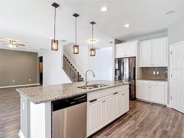 7628 Surf Reed Way, Wesley Chapel, FL 33545 - kitchen with stainless steel appliances, a sink, ceiling fan, recessed lighting, and a center island with sink