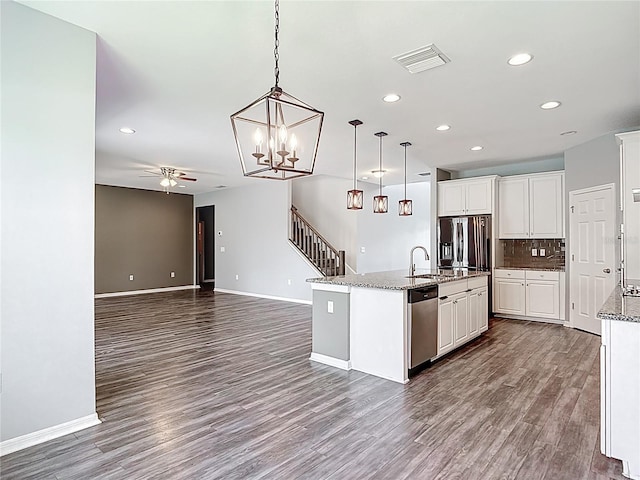 7628 Surf Reed Way, Wesley Chapel, FL 33545 - kitchen with stainless steel appliances, a ceiling fan, recessed lighting, a sink, and dark wood finished floors
