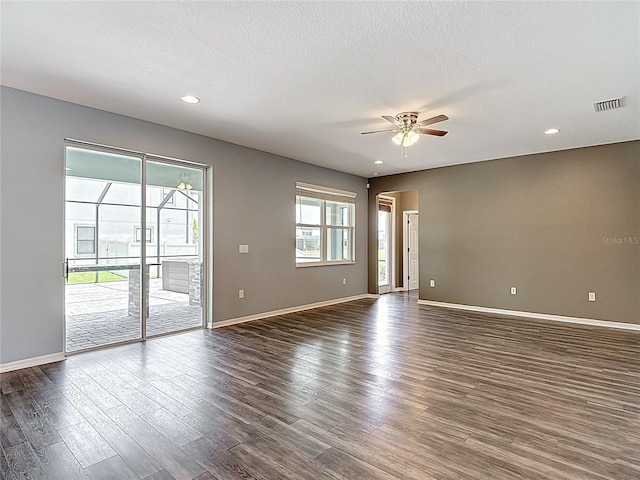 7628 Surf Reed Way, Wesley Chapel, FL 33545 - spare room featuring a ceiling fan, dark wood-style flooring, baseboards, recessed lighting, and arched walkways