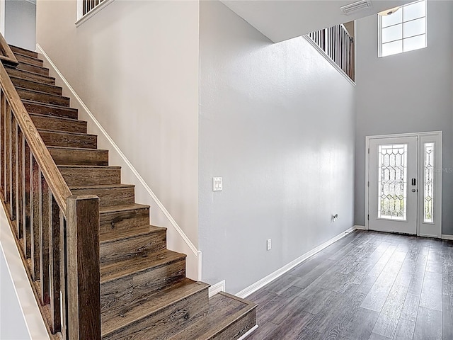 7628 Surf Reed Way, Wesley Chapel, FL 33545 - foyer entrance featuring stairway, baseboards, a towering ceiling, and dark wood finished floors