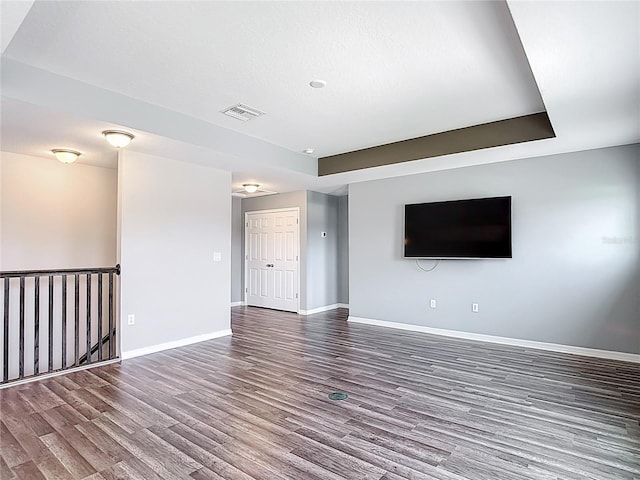 7628 Surf Reed Way, Wesley Chapel, FL 33545 - unfurnished living room featuring wood finished floors and baseboards