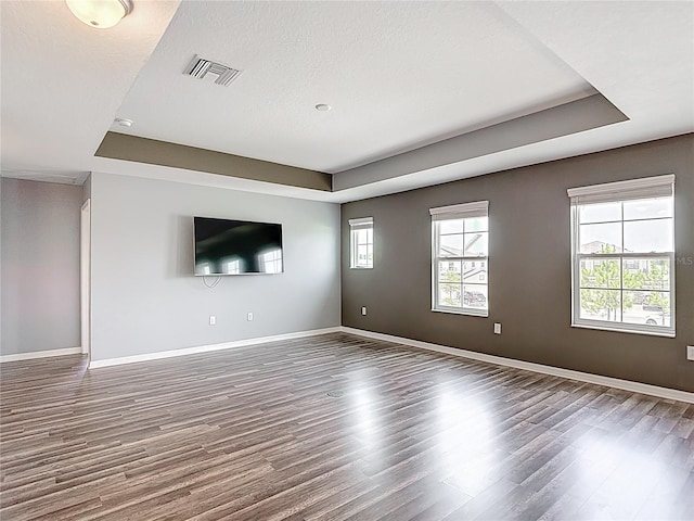 7628 Surf Reed Way, Wesley Chapel, FL 33545 - empty room with a raised ceiling, wood finished floors, and baseboards