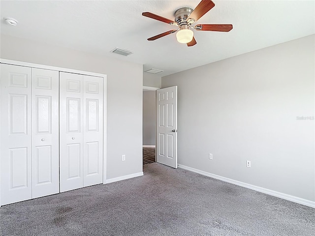 7628 Surf Reed Way, Wesley Chapel, FL 33545 - unfurnished bedroom with carpet floors, a closet, baseboards, and a ceiling fan
