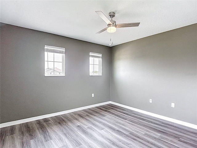 7628 Surf Reed Way, Wesley Chapel, FL 33545 - empty room featuring a ceiling fan, wood finished floors, and baseboards