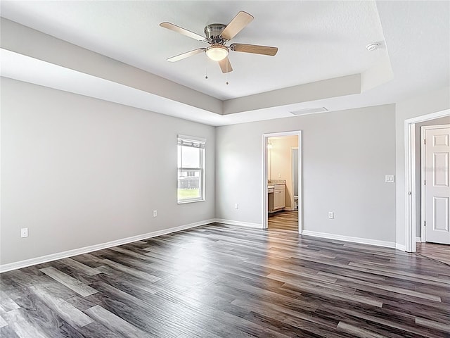 7628 Surf Reed Way, Wesley Chapel, FL 33545 - spare room with dark wood finished floors, a raised ceiling, and baseboards